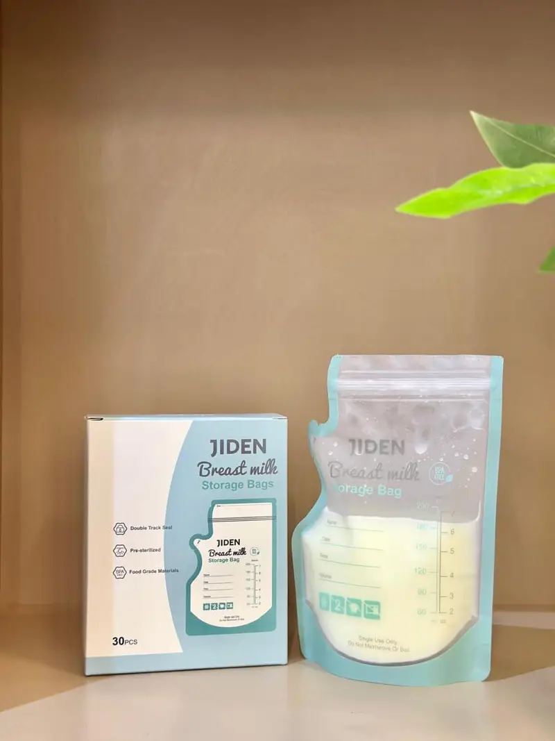 Jiden pre-sterilised BPA-free breastmilk storage bag filled with milk beside its 30-piece box